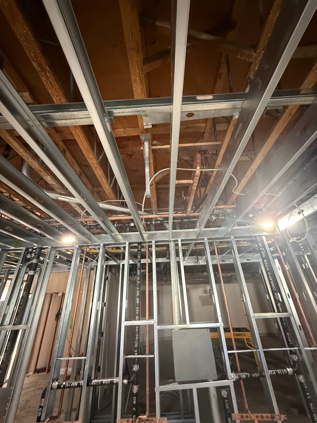 Industrial interior with metal framing and exposed wiring in a construction site.