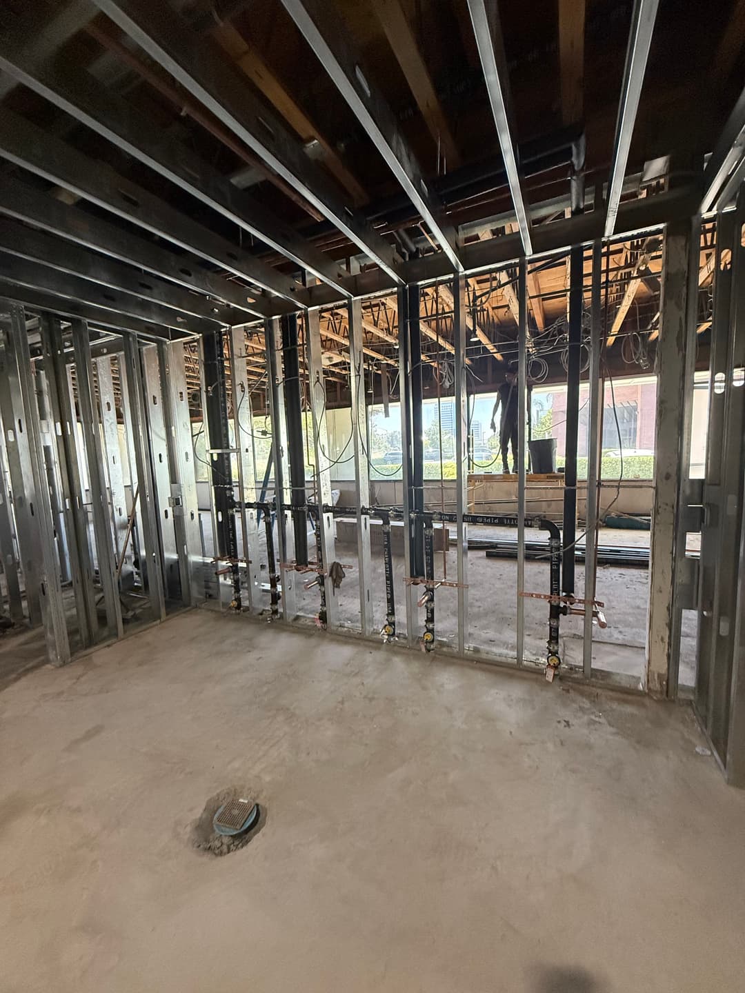 Interior of a construction site showing framed walls and plumbing ready for installation.